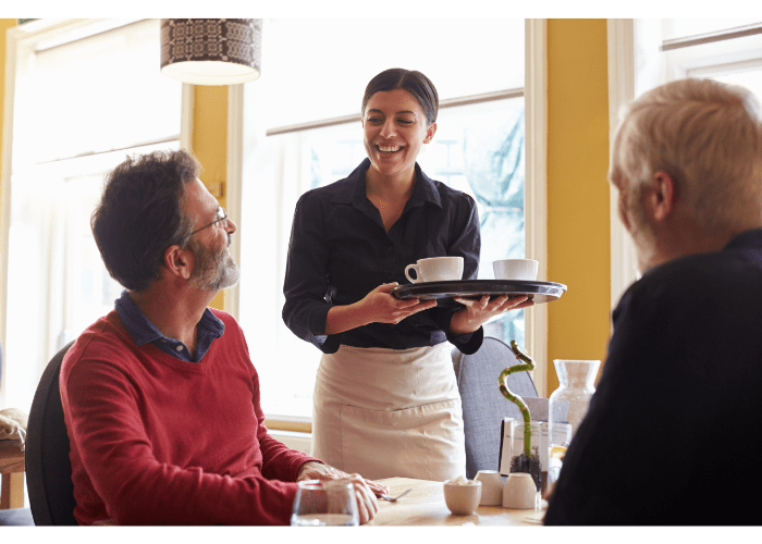 Waitress brings coffee to customers